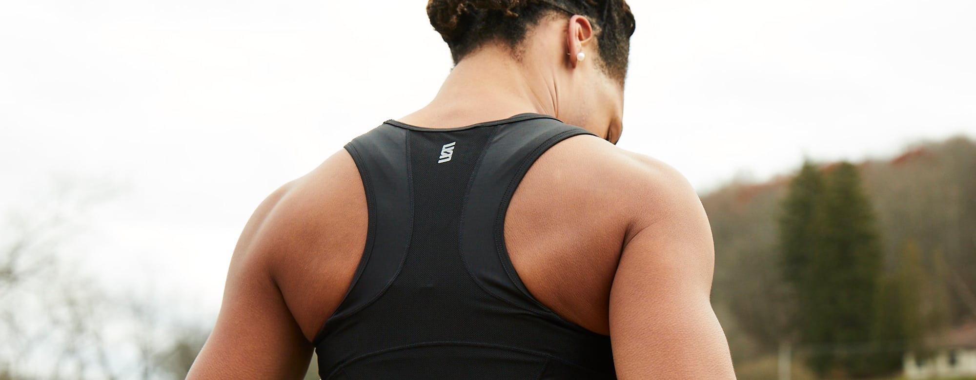 Back view of a runner athlete in tank top