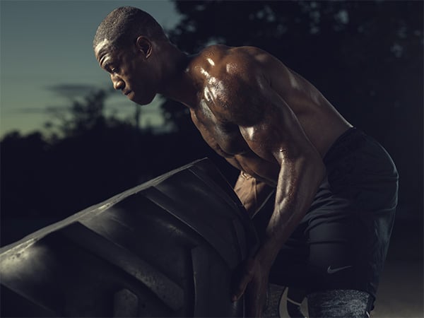 strong athlete flipping a tire