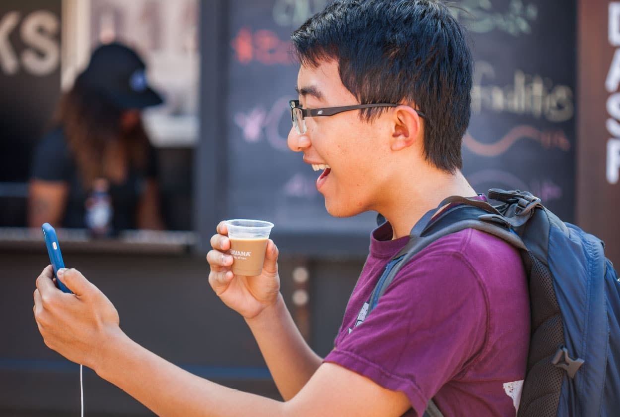young man drinking coffee, laughing