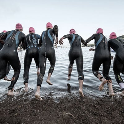 Group of swimmers in wetsuits