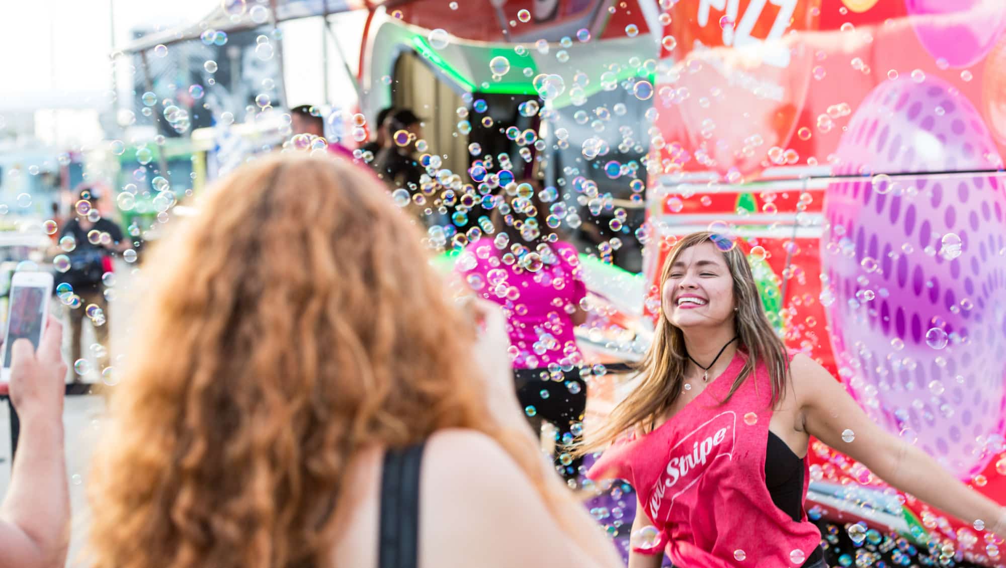 women laughing, blowing bubbles