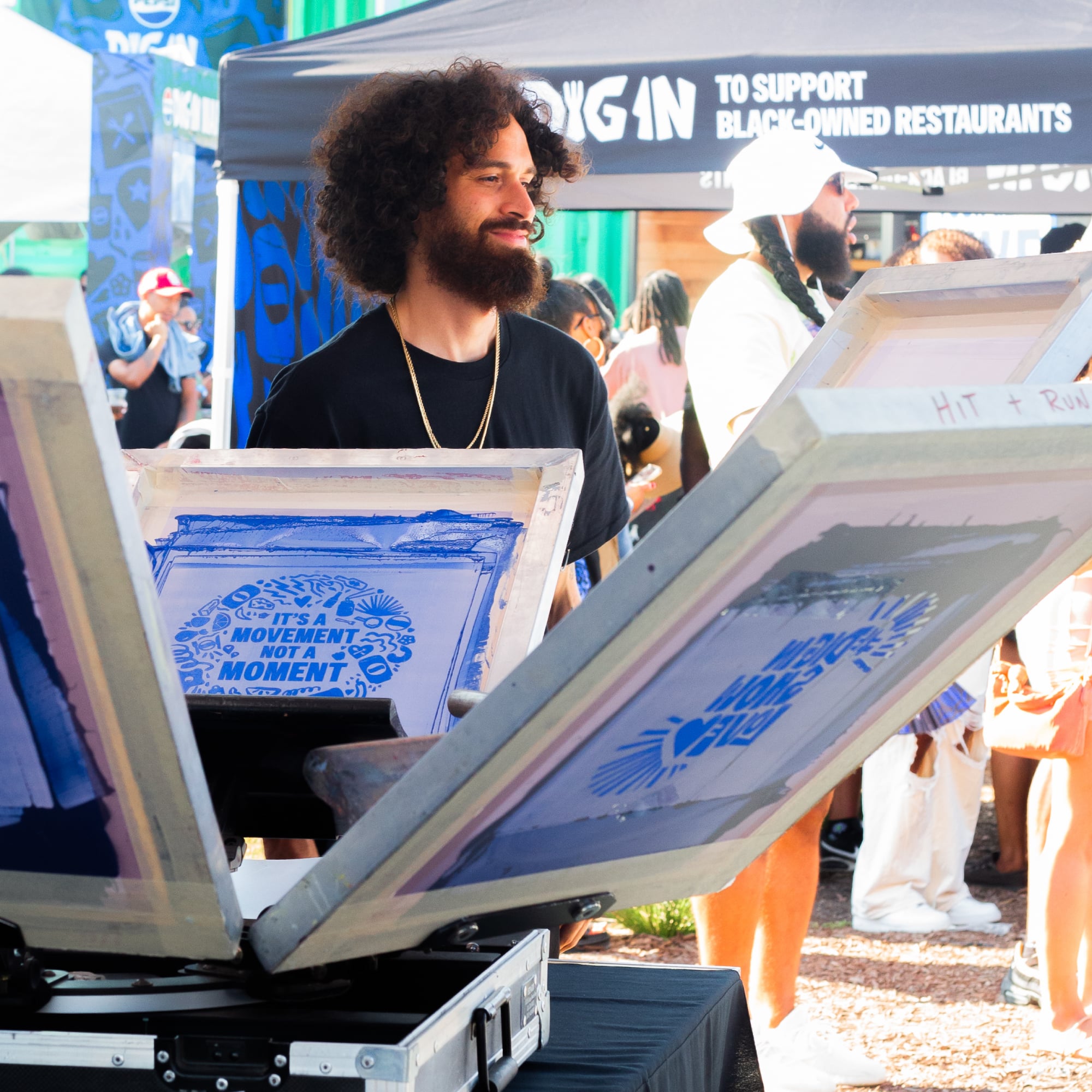 Man making silk screen t-shirts at Dig in Day